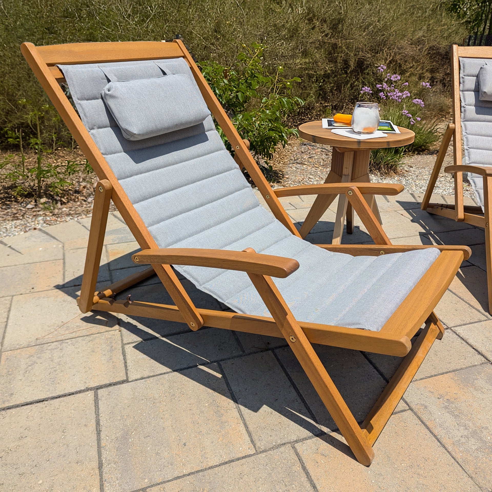 Clara deck chair with gray cushions on a patio