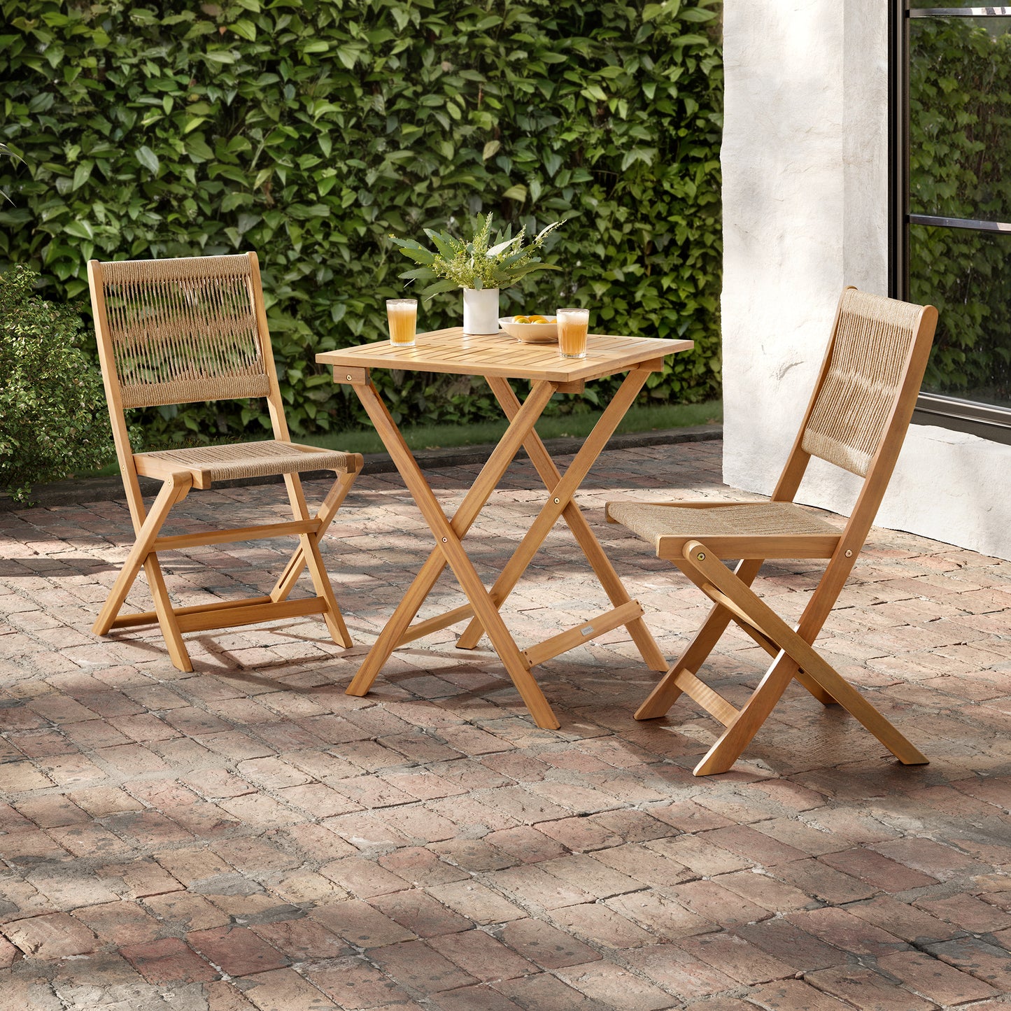 Brixi acacia wood and rope bistro table and chairs set on patio