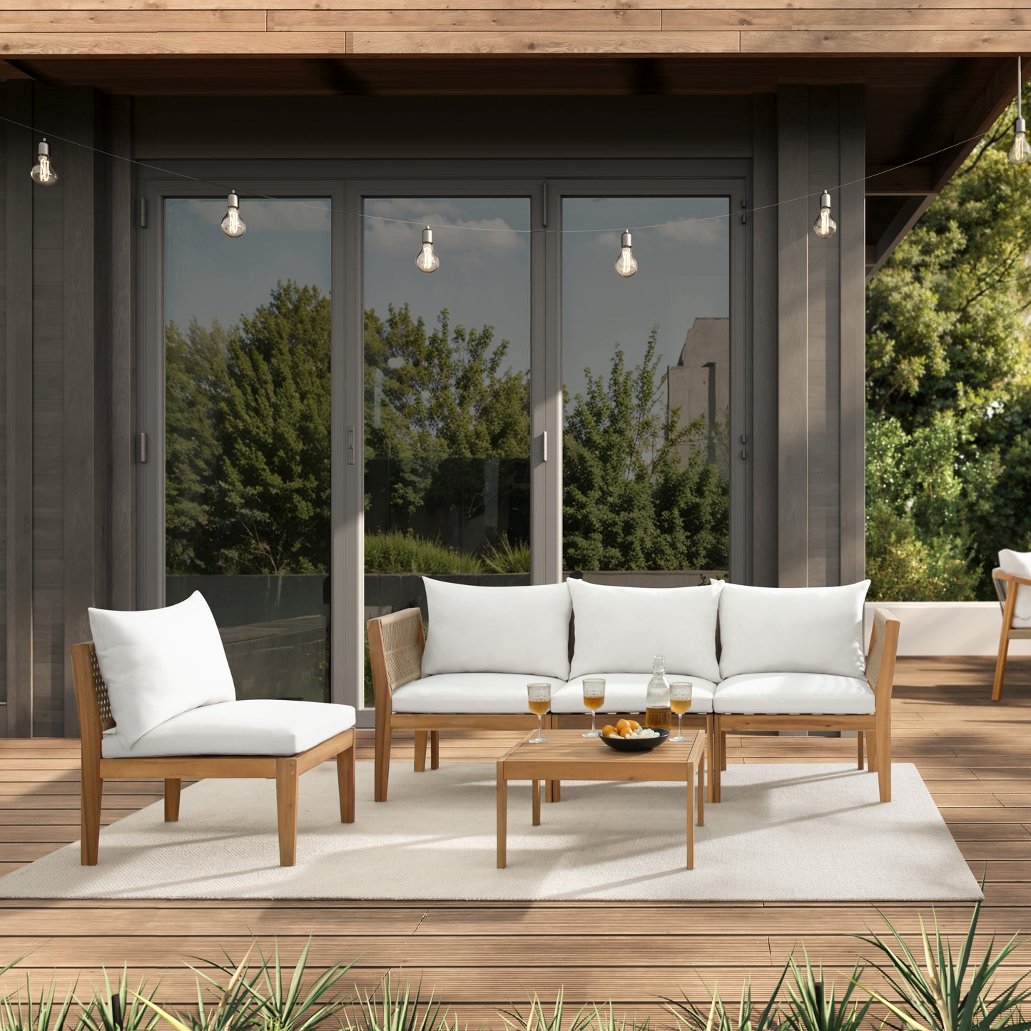 modern backyard patio with Kyndway Dara Modular acacia wood and rope furniture