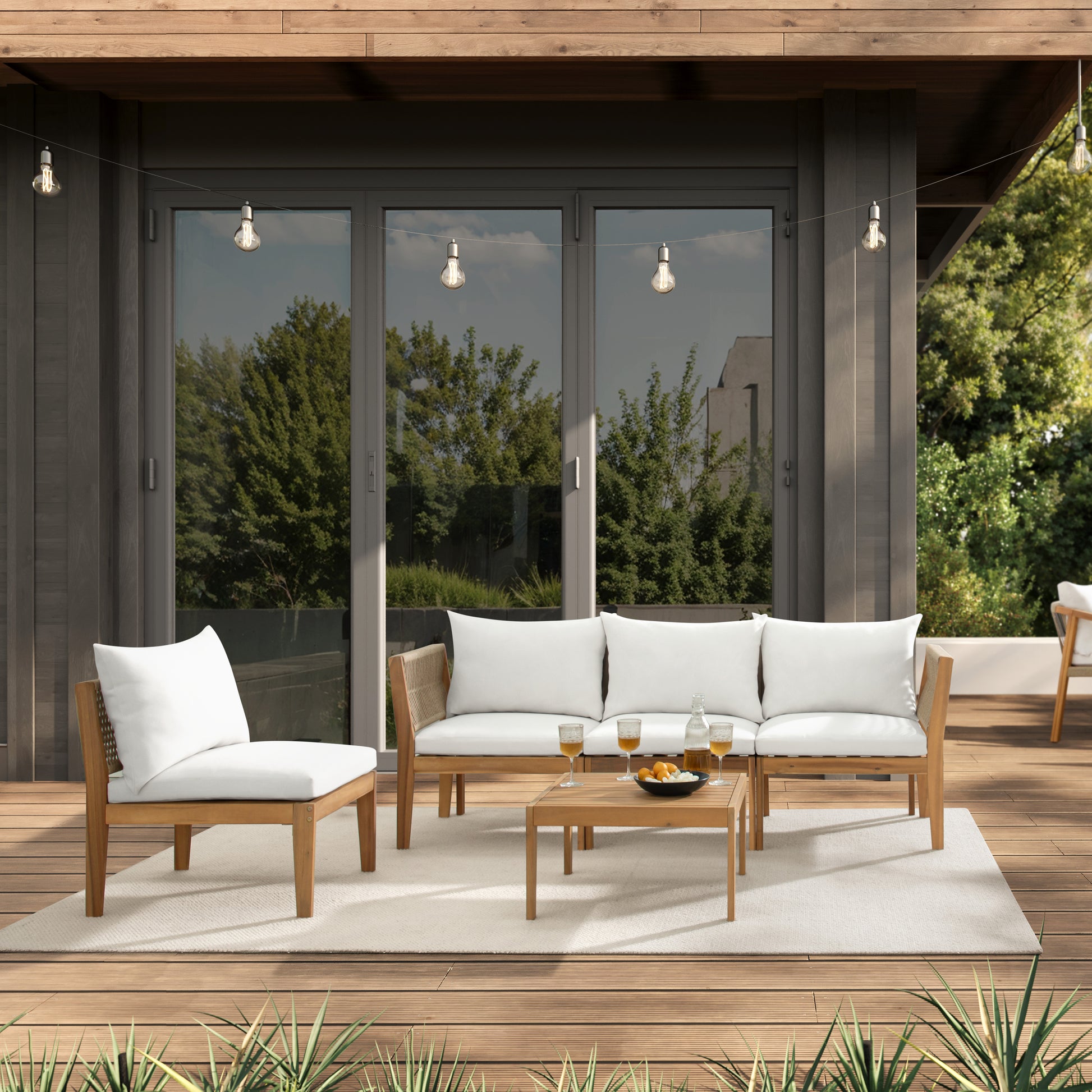 modern backyard patio with Kyndway Dara Modular acacia wood and rope furniture